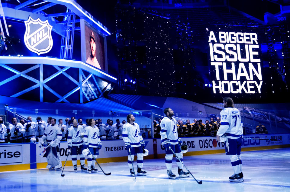 TORONTO, ONTARIO - AUGUST 29:  Tampa Bay Lightning players watch as a video message plays on arena screens to show solidarity against racism before Game Four of the Eastern Conference Second Round against the Boston Bruins during the 2020 NHL Stanley Cup Playoffs at Scotiabank Arena on August 29, 2020 in Toronto, Ontario. (Photo by Mark Blinch/NHLI via Getty Images)