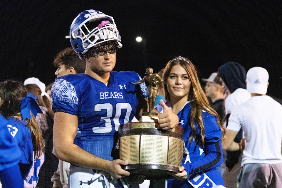 Pleasant Valley's (30) Alexander Ecker poses with the bucket at the end of the game on Oct 20, 2023.