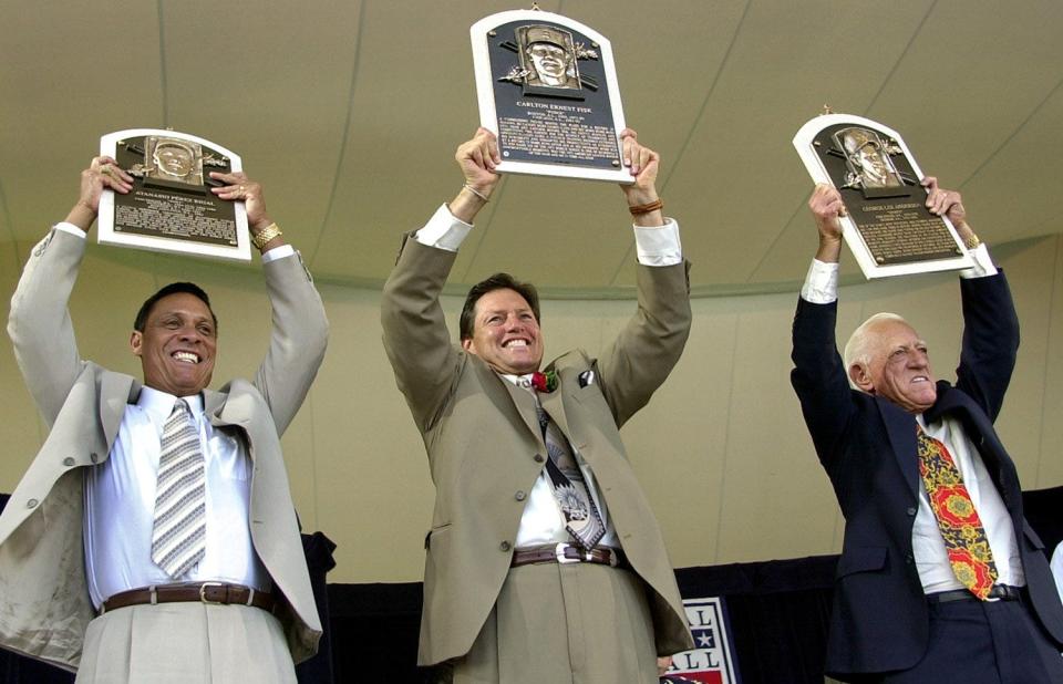 Text: 2000.0723.10.1--HALL OF FAME--nikon digital image--From left, Tony Perez, Carlton Fisk and Sparky Anderson hold up their Hall of fame plaques at the Baseball Hall of Fame iduction ceremony in Cooperstown, NY Sunday. Photo by Craig Ruttle/Cincinnati Enquirer