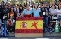 Japanese fans display a banner in the colours of the Spanish flag commemorating the late Marussia test driver Maria De Villota of Spain, at the entrance to the Suzuka circuit ahead of the Japanese F1 Grand Prix in Suzuka, western Japan October 13, 2013. Formula One drivers will hold a minute's silence at the Japanese Grand Prix on Sunday and dedicate the winner's podium to De Villota, they said on Saturday. De Villota, 33, who lost her right eye and fractured her skull in a freak accident during a straight line aerodynamic test in England in July 2012, was found dead in a hotel in her native Spain on Friday. REUTERS/Issei Kato (JAPAN - Tags: SPORT MOTORSPORT F1 OBITUARY)