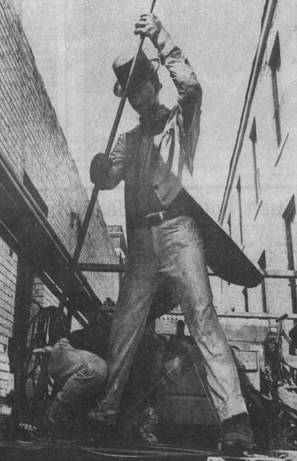 Duke Corning from Custom Metals of Madison, makes adjustments on the Billy Bud statue before it's put atop the Jung Shoe Co. chimney, as seen, August 1992, in Sheboygan, Wis.