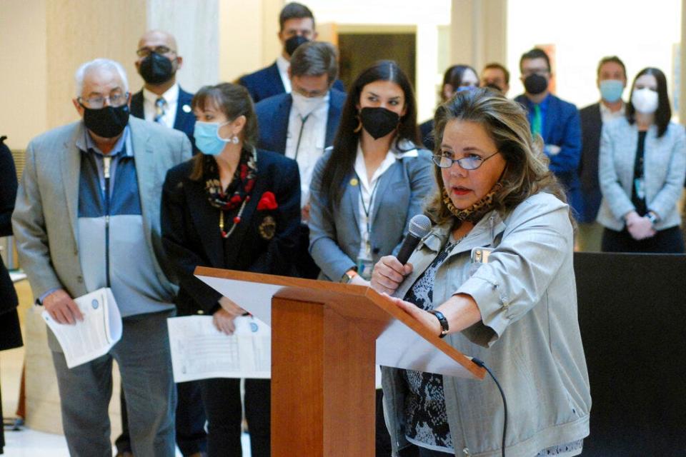 New Mexico legislators including Democratic state Rep. Patricia Lundstrom of Gallup, foreground, proposed a $1 billion increase in general fund spending for the coming fiscal year, at a news conference in Santa Fe, N.M., on Thursday, Jan. 6, 2022. The proposed 14% boost is aimed at shoring up access to health care, improving public education and providing new investments in child welfare and public safety. A separate proposal from Gov. Michelle Lujan Grisham shares many spending priorities.