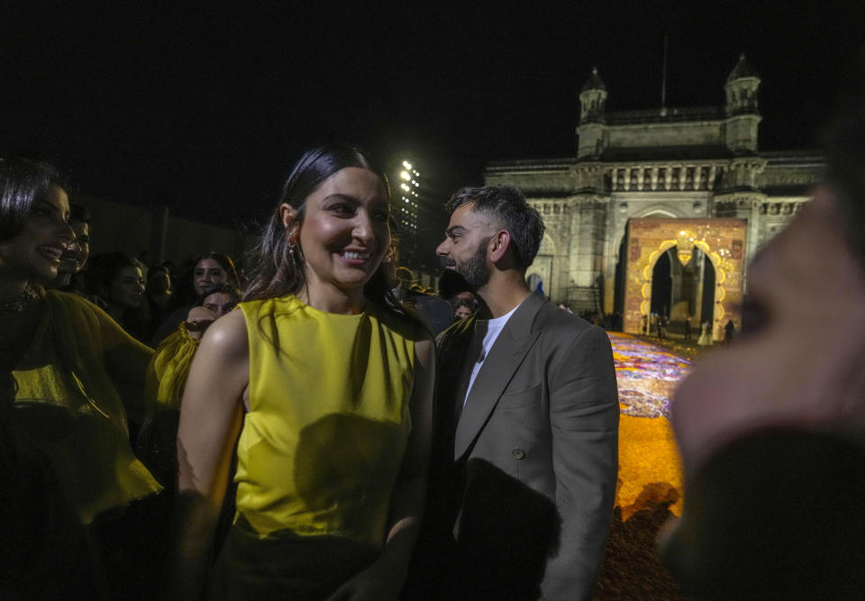 Indian cricketer Virat Kohli, right, leaves with his wife Anushka Sharma at the end of the Dior Pre-Fall 2023 collection at the Gateway of India landmark monument in Mumbai, India, Thursday, March 30, 2023. (AP Photo/Rafiq Maqbool)