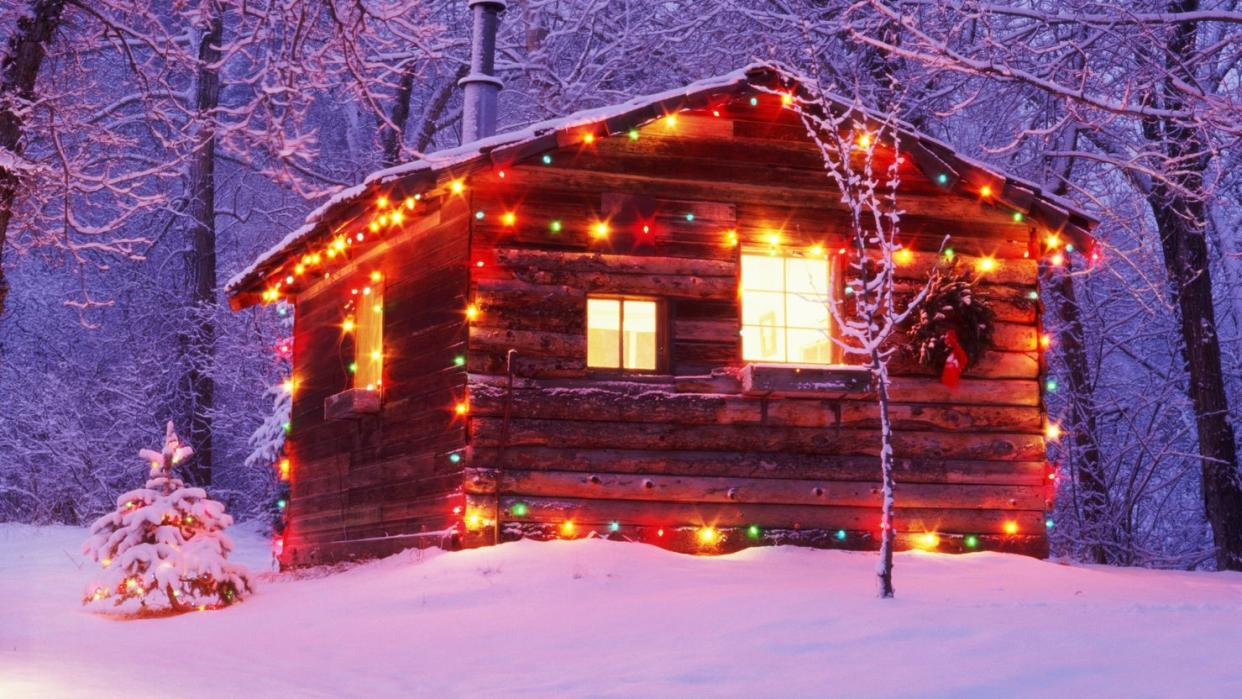 log cabin exterior decorated with christmas lights, winter, dusk