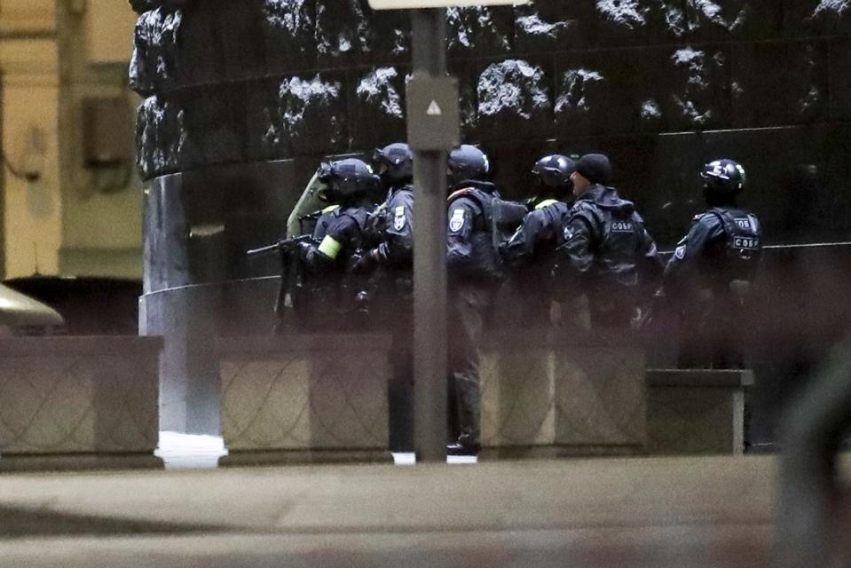 Russian special forces secure the area at the building of the Federal Security Service (FSB, Soviet KGB successor) in the background in Moscow, Russia, Thursday, Dec. 19, 2019. Russia's main security agency says shots have been fired near its headquarters in downtown Moscow. (AP Photo/Pavel Golovkin)