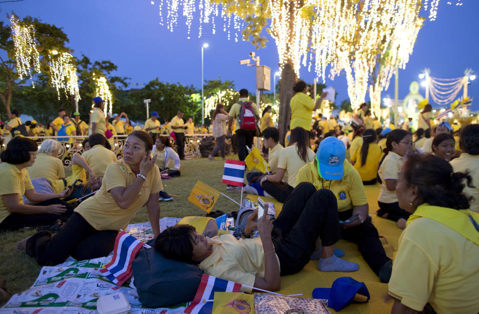 Wellwishers wait to see King Maha Vajiralongkorn pass through the streets during his coronation ceremony Sunday, May 5, 2019, in Bangkok, Thailand. Vajiralongkorn was officially crowned amid the splendor of the country's Grand Palace, taking the central role in an elaborate centuries-old royal ceremony that was last held almost seven decades ago. (AP Photo/Gemunu Amarasinghe)