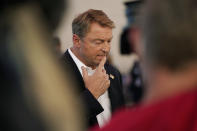 Former U.S. Sen. Dean Heller, center, speaks with the media at an event at Share Village Las Vegas after announcing a bid for governor of Nevada, Monday, Sept. 20, 2021, in Las Vegas. (AP Photo/John Locher)