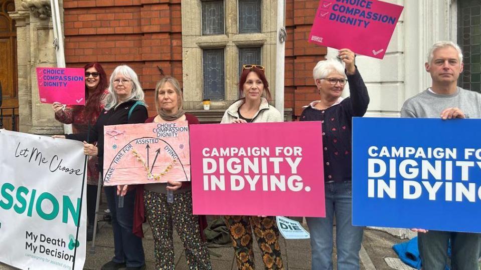Campaigners with Dignity in Dying signs outside the House of Keys