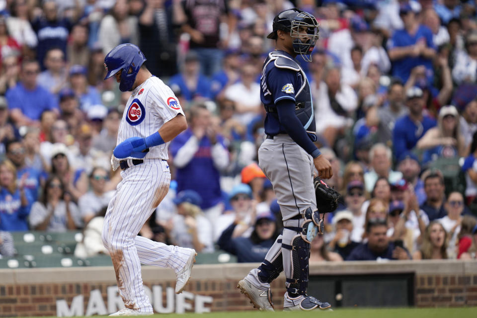 Chicago Cubs' Seiya Suzuki jogs past Tampa Bay Rays catcher Christian Bethancourt to score during the fourth inning of a baseball game, Monday, May 29, 2023, in Chicago. (AP Photo/Erin Hooley)