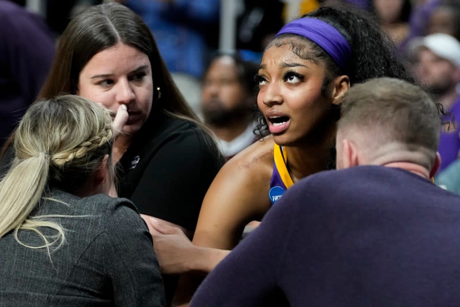 LSU forward Angel Reese (10) talks with coaches on the bench during the first half of an Elite Eight round college basketball game against Iowa during the NCAA Tournament, Monday, April 1, 2024, in Albany, N.Y. (AP Photo/Mary Altaffer)