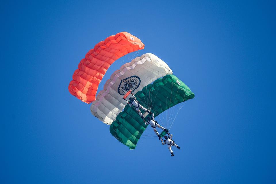 Indian Air Force (IAF) paratroopers from the 'Akashganga' skydiving team glide during the 88th Air Force Day parade at Hindon Air Force station in Ghaziabad on October 8, 2020. (Photo by Money SHARMA / AFP) (Photo by MONEY SHARMA/AFP via Getty Images)