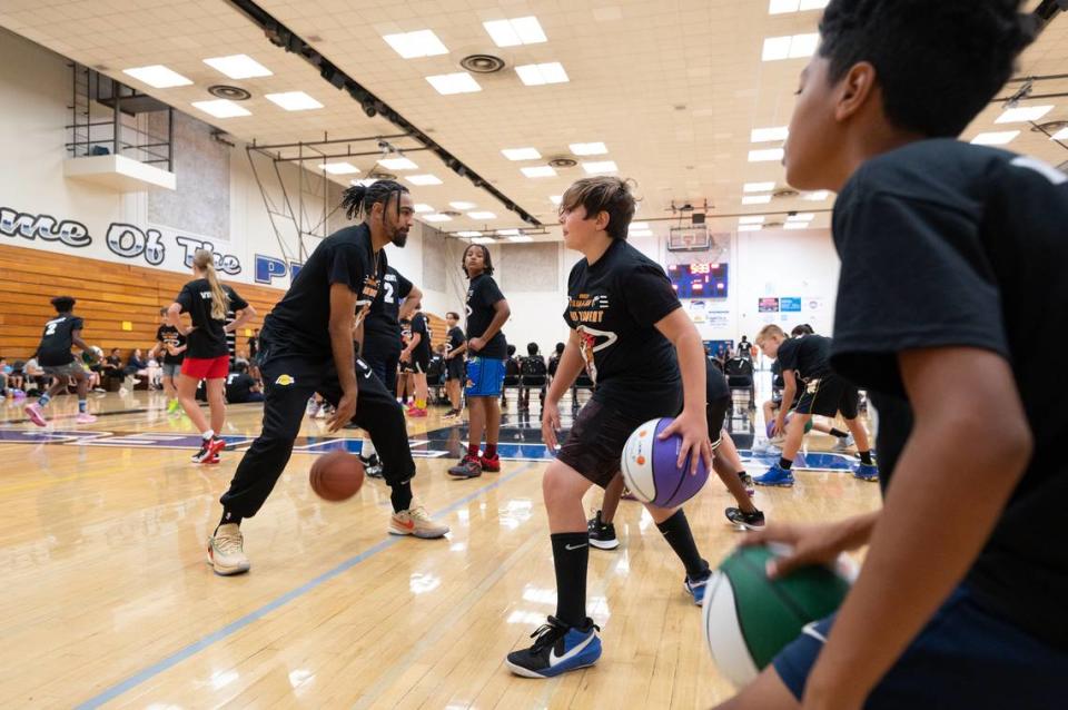 NBA player Gabe Vincent leads a drill during the Modesto Slam-N-Jam Youth Basketball Camp at Modesto Junior College in Modesto, Calif., Friday, July 7, 2023.