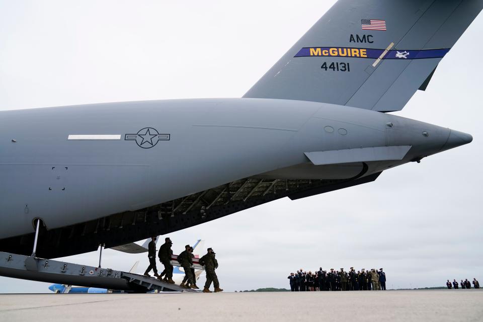 A military carry team moves a transfer case Sunday, Aug. 29, 2021, at Dover Air Force Base, containing the remains of one of the U.S. troops who was killed in a suicide bombing in Kabul, Afghanistan on Aug. 26, during a casualty return for 11 of the 13 of the service members.