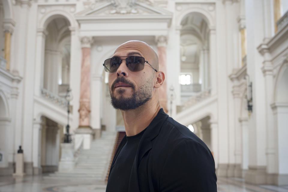 FILE - Andrew Tate walks inside the Court of Appeals building in Bucharest, Romania, Thursday, May 30, 2024. A court in Romania's capital on Friday, July 5, 2024 ruled that the online influencer Andrew Tate can leave Romanian territory providing he remains within the European Union, as he awaits trial on charges of human trafficking, rape and forming a criminal gang to sexually exploit women. (AP Photo/Andreea Alexandru, File)