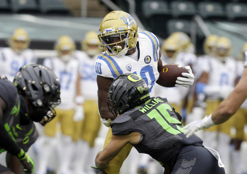 UCLA's Demetric Felton, left, is tackled by Oregon's Bennett Williams during the first quarter of an NCAA college football game Saturday, Nov. 21, 2020, in Eugene, Ore. (AP Photo/Chris Pietsch)