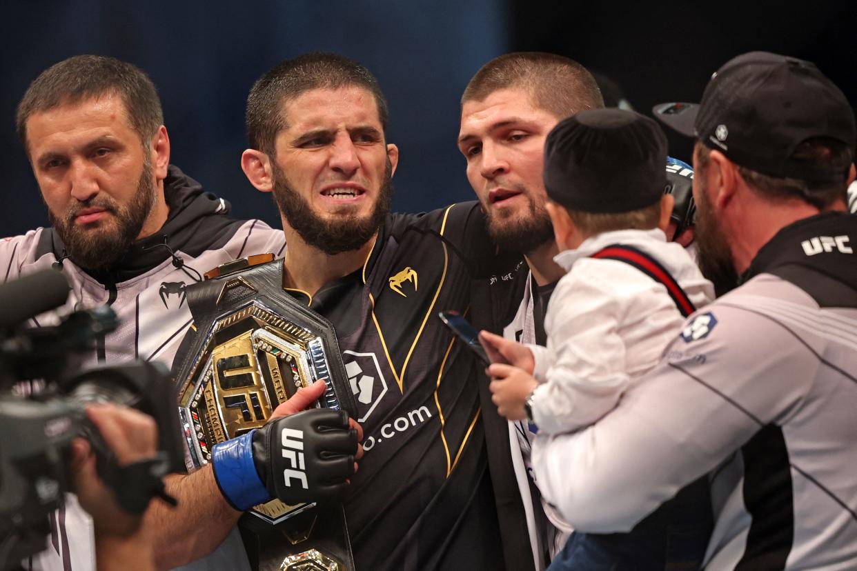 Islam Makhachev (2nd-L) celebrates with his team after defeating Charles Oliveira in the lightweight championship at the Ultimate Fighting Championship (UFC) event at the Etihad Arena in Abu Dhabi on October 22, 2022. (Photo by Giuseppe CACACE / AFP) (Photo by GIUSEPPE CACACE/AFP via Getty Images)