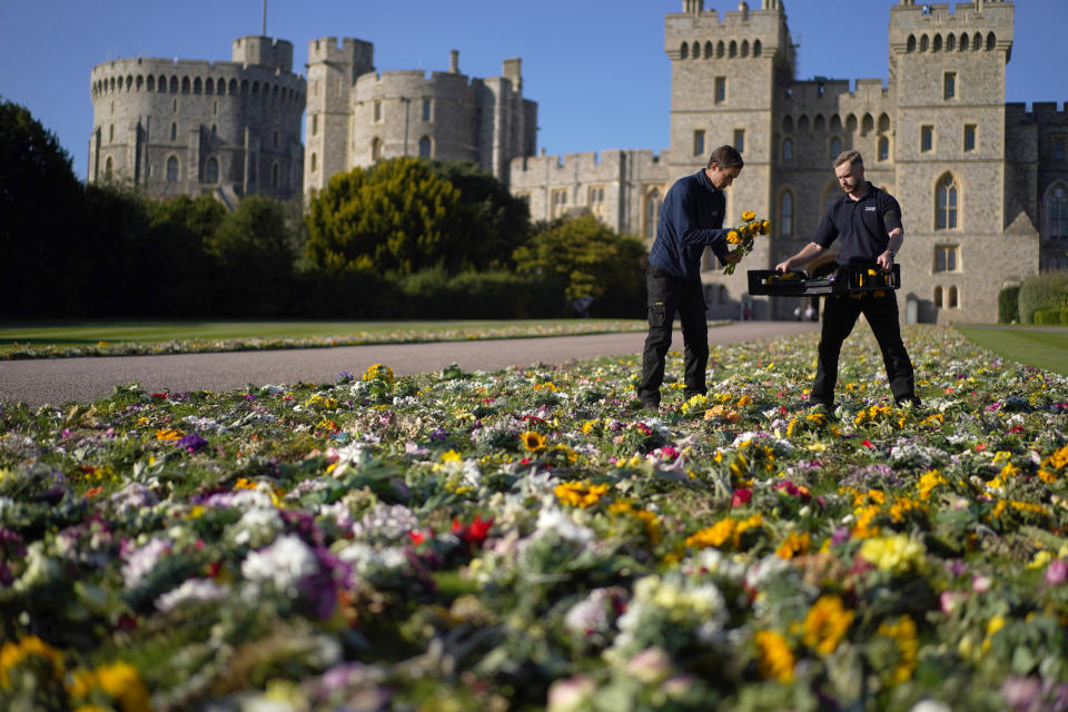 Workers from the Crown Estate move the floral tributes laid by members of the public outside Windsor Castle onto Cambridge Drive, near the Long Walk, Windsor, ahead of the funeral of Queen Elizabeth II on Monday. Picture date: Saturday September 17, 2022. (Photo by Victoria Jones/PA Images via Getty Images)