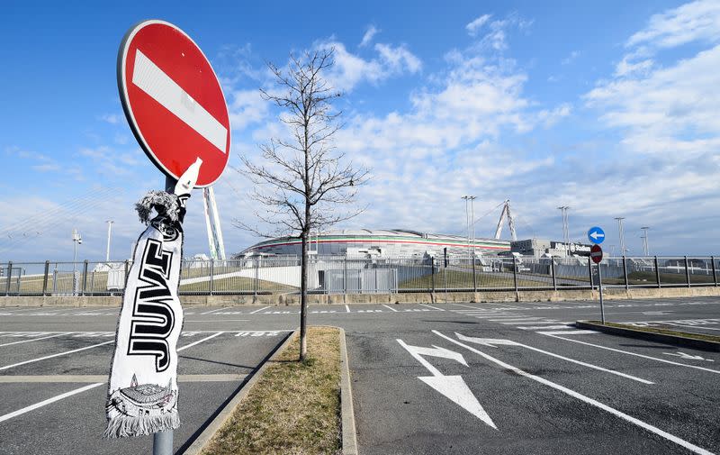 Juventus Football Club scarf is attached to a no entry sign outside the Allianz Stadium in Turin