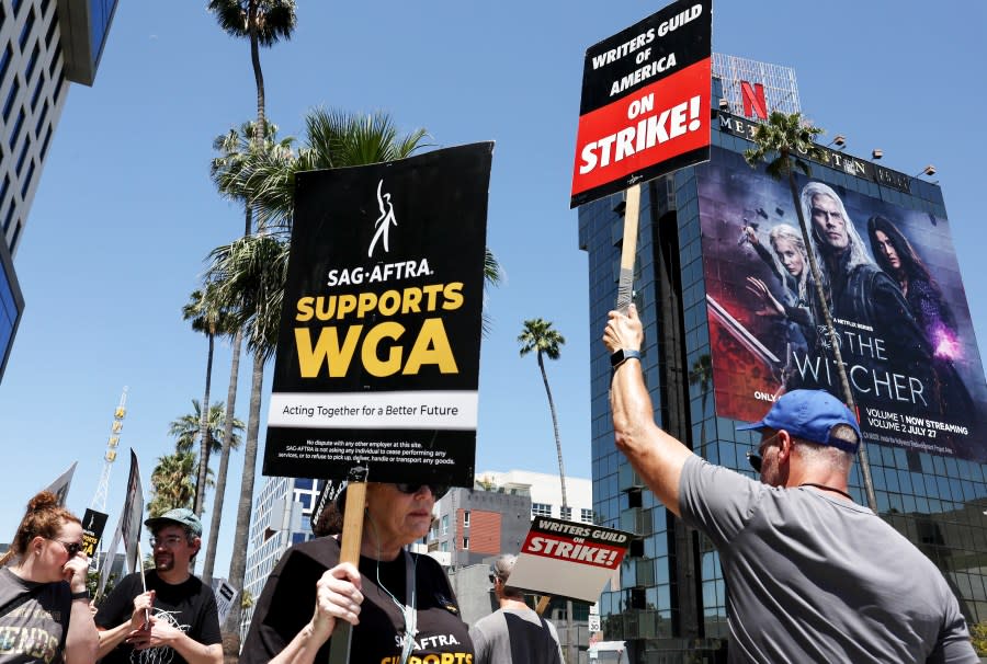 A sign reads "SAG-AFTRA Supports WGA" as SAG-AFTRA members walk the picket line in solidarity with striking WGA workers outside Netflix offices on July 11, 2023, in Los Angeles. (Mario Tama/Getty Images)