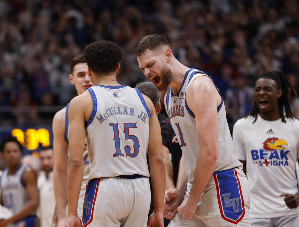 Kansas center Hunter Dickinson (1) reacts during a timeout after a score by Kevin McCullar Jr. (15) during the first half of an NCAA college basketball game, against Houston, Saturday, Feb. 3, 2024, in Lawrence, Kan. (AP Photo/Colin E. Braley)