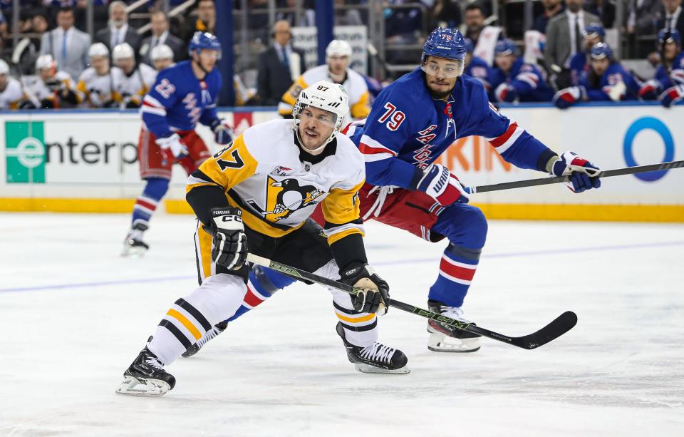 Apr 1, 2024; New York, New York, USA; Pittsburgh Penguins center Sidney Crosby (87) and New York Rangers defenseman K'Andre Miller (79) battle for the puck during the first period at Madison Square Garden.