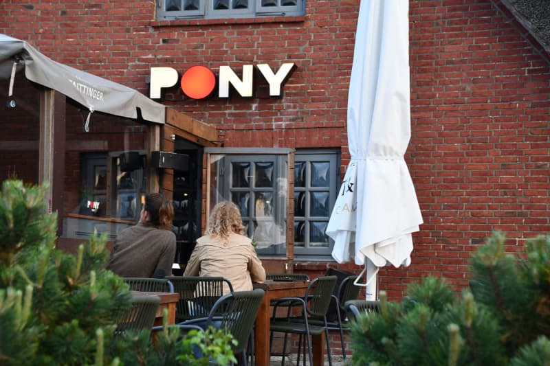 Two women sit on the terrace of the "Pony" club in Kampen (Sylt). A video shared online of young Germans chanting racist anti-immigrant slogans outside a pub on the North Sea island of Sylt has sparked outrage in the country. Lea Sarah Albert/dpa