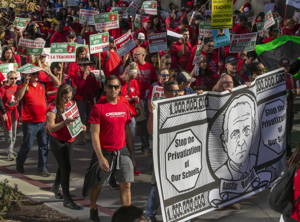 In this Saturday, Dec. 15, 2018, photo, thousands of teachers marched and rallied in downtown Los Angeles. Teachers in the nation's second-largest school district will go on strike next month if there's no settlement of its long-running contract dispute, union leaders said Wednesday, Dec. 19. The announcement by United Teachers Los Angeles threatens the first strike against the Los Angeles Unified School District in nearly 30 years and follows about 20 months of negotiations. (AP Photo/Damian Dovarganes)