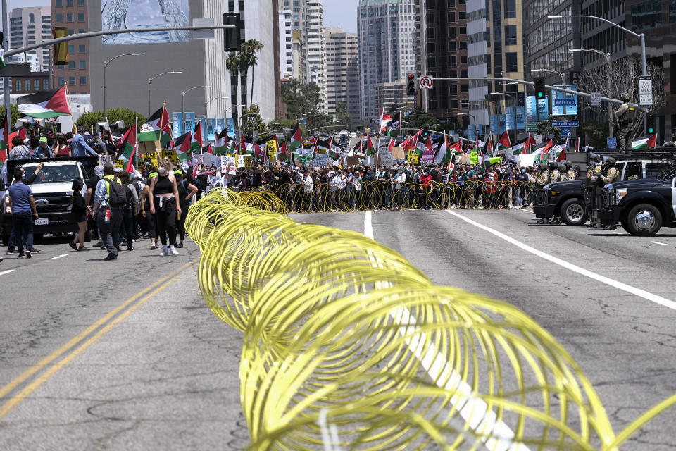 Police officers keep watch outside the Federal Building as demonstrators march to Israeli Consulate during a protest against Israel and in support of Palestinians, Saturday, May 15, 2021 in the Westwood section of Los Angeles. (AP Photo/Ringo H.W. Chiu)