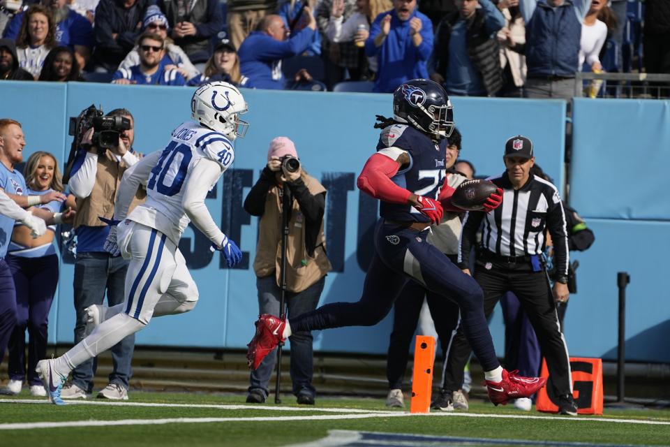 Tennessee Titans' Derrick Henry (22) runs past Indianapolis Colts' Jaylon Jones (40) for a touchdown during the first half of an NFL football game, Sunday, Dec. 3, 2023, in Nashville, Tenn. (AP Photo/George Walker IV)