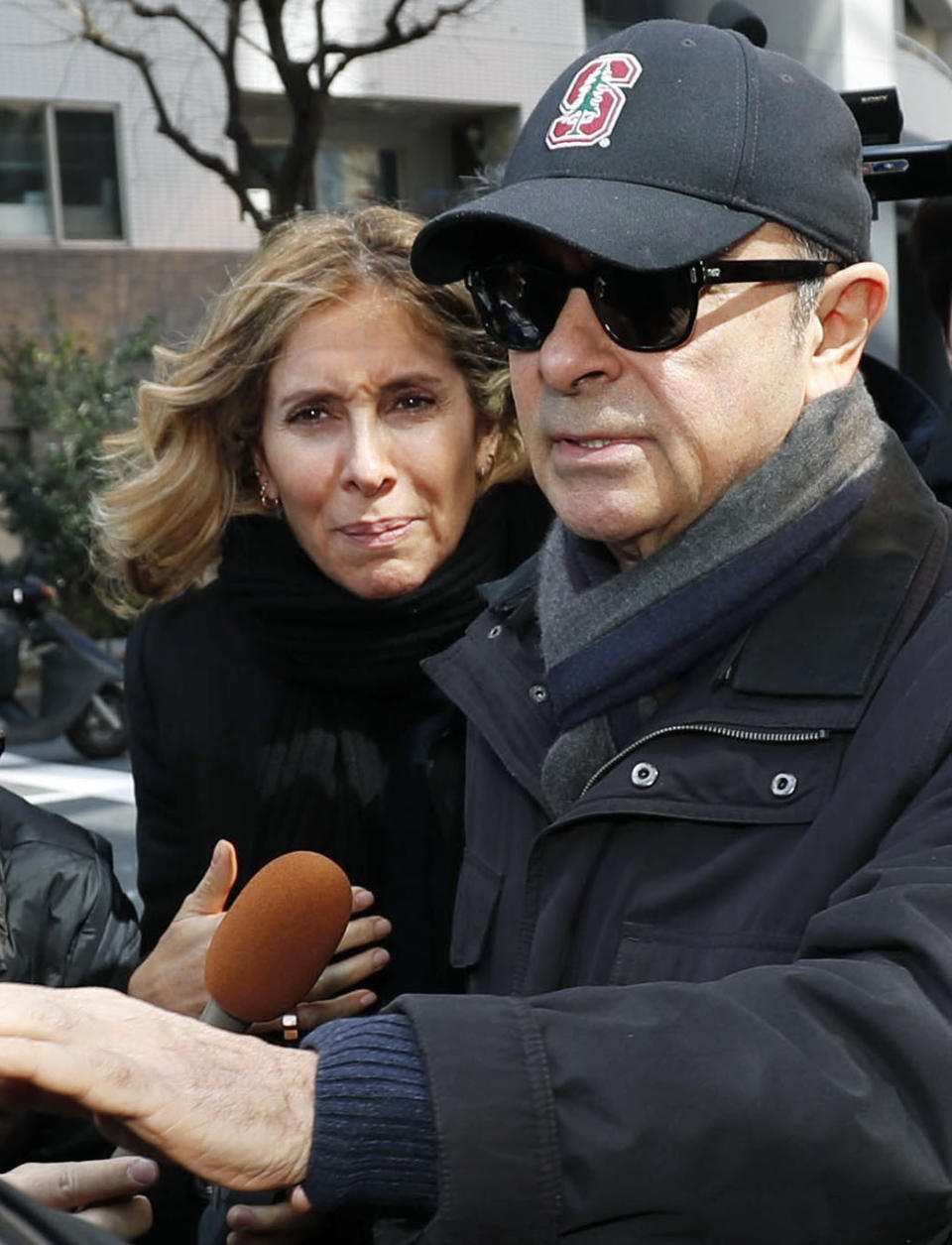 This March, 2019, photo shows former Nissan Chairman Carlos Ghosn, right, and his wife Carole in Tokyo. Japanese prosecutors said Monday, April 22, 2019, they have indicted Nissan’s former chairman Ghosn with additional charges of breach of trust, with his alleged misconduct expanding outside Japan. (Kyodo News via AP)