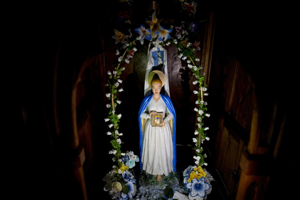 A staue of Argentine former first lady María Eva Duarte de Perón, better known as Eva Perón, or Evita, depicting her as a saint, adorns a niche inside the Peron Peron restaurant in the San Telmo neighborhood of Buenos Aires, Argentina, Friday, Feb. 9, 2024. (AP Photo/Natacha Pisarenko)