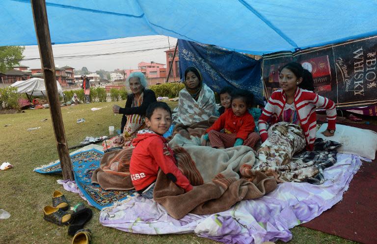 A Nepalese family rest in their makeshift shelter in Kathmandu, on April 27, 2015