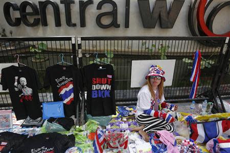 A vendor sells accessories to anti-government protesters at one of their encampment in Bangkok's shopping district March 1, 2014. REUTERS/Damir Sagolj