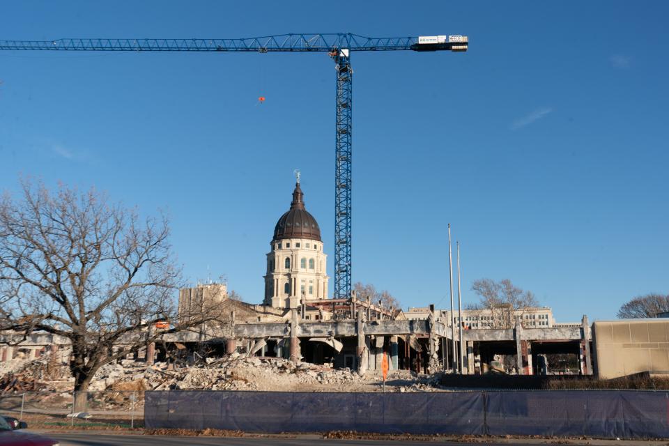 The Kansas Statehouse shows above the lower floors of the Docking State Office Building, which is nearing completion.