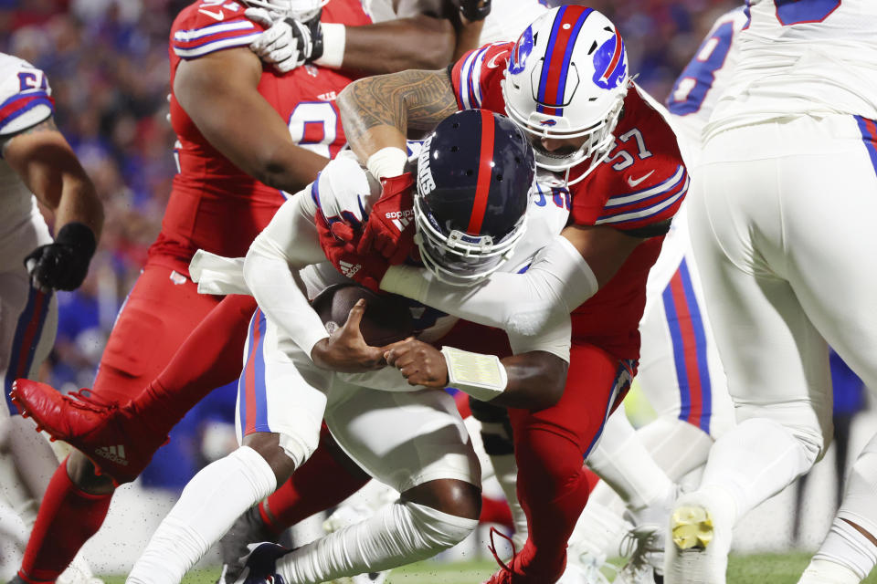 Buffalo Bills defensive end AJ Epenesa sacks New York Giants quarterback Tyrod Taylor (2) during the first half of an NFL football game in Orchard Park, N.Y., Sunday Oct. 15, 2023. (AP Photo/ Jeffrey T. Barnes)