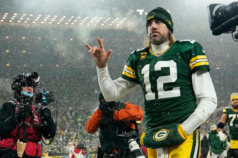 Quarterback Aaron Rodgers #12 of the Green Bay Packers gestures as he exits the field after losing the NFC Divisional Playoff game to the San Francisco 49ers at Lambeau Field on January 22, 2022 in Green Bay, Wisconsin.