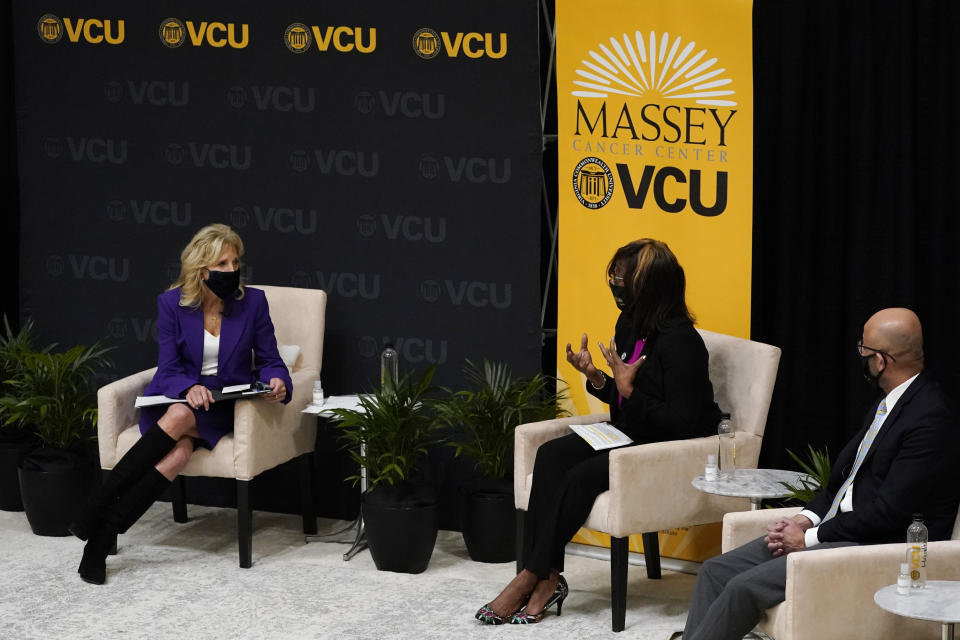 First lady Jill Biden, left, listens to speakers during a forum at the Massey Cancer center at Virginia Commonwealth University for a discussion about cancer disparities. in Richmond, Va., Wednesday, Feb. 24, 2021. (AP Photo/Steve Helber)