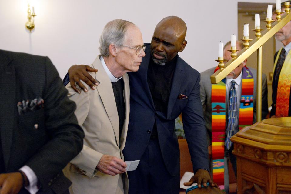 The Rev. LaPrince Edwards, right, and Father Jim Abbott, left are seen in this file photo. Abbott, a resident of East End/Valley Street, said the church conversion into housing would help prevent further gentrification in the neighborhood.