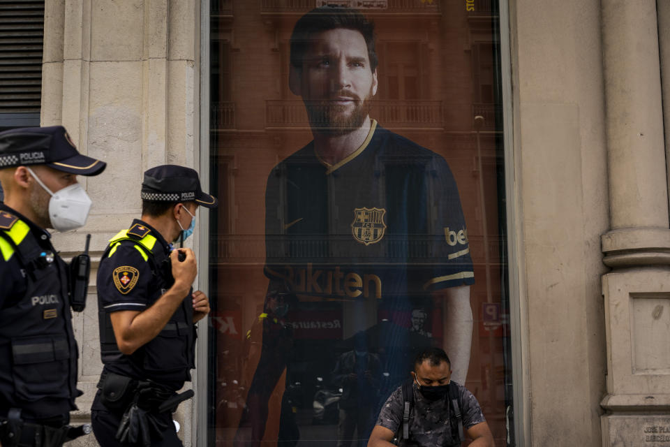 A poster with the face of Barcelona soccer player Lionel Messi is displayed at a F.C. Barcelona store in Barcelona, Spain on Tuesday, Sept. 1, 2020. Barcelona is banking on a face-to-face meeting with Lionel Messi to try to convince him to stay. Talks with Messi’s father-agent are expected this week in Barcelona but the club also hopes to sit down with the player himself. (AP Photo/Emilio Morenatti)