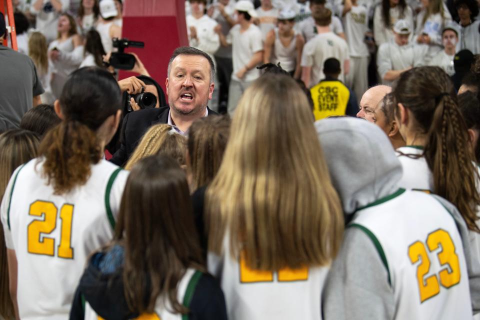 Lansdale Catholic girls basketball head coach Eric Gidney joins the team huddle after their victory at the Palestra in Philadelphia on Monday, Feb. 27, 2023. Lansdale Catholic defeated Archbishop Wood in the PCL girls basketball final, 50-47.