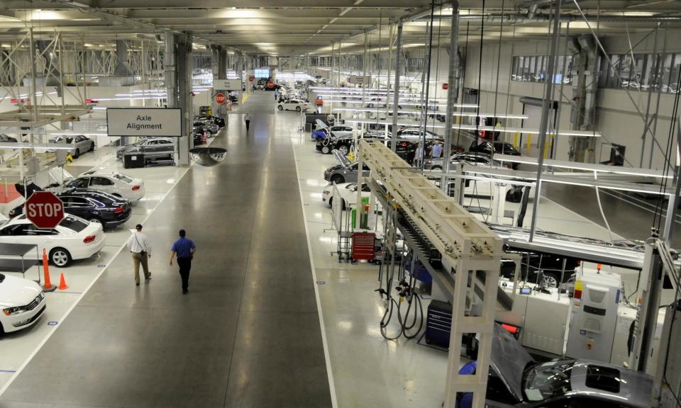 <span>Two Volkswagen employees walk through the axle alignment department in Chattanooga, Tennessee.</span><span>Photograph: Billy Weeks/Reuters</span>