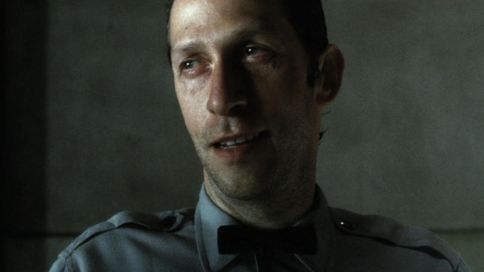 Tim Blake Nelson smiles creepily in Minority Report.