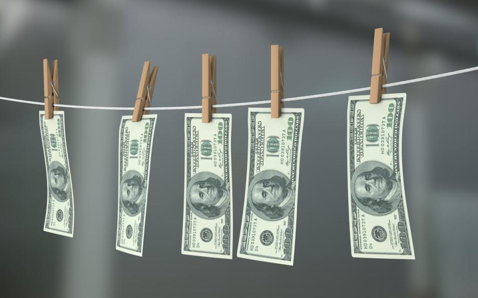 One-hundred-dollar bills drying on a clothes line.