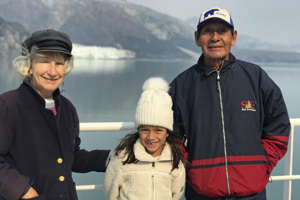 This July 2019 photo provided by Miguel Gonzalez, shows Margrit and Lucio Gonzalez with their granddaughter, Caylie Gonzalez, in Alaska. They are suing Princess Cruises and owner Carnival Corp. for negligence and wrongful death — one of dozens of lawsuits by passengers and surviving relatives. Lucio Gonzalez died of coronavirus.“They put him on a ventilator for three weeks and two days, and after that he died,” his widow said. “I never saw him alive again.” (Miguel Gonzalez via AP)