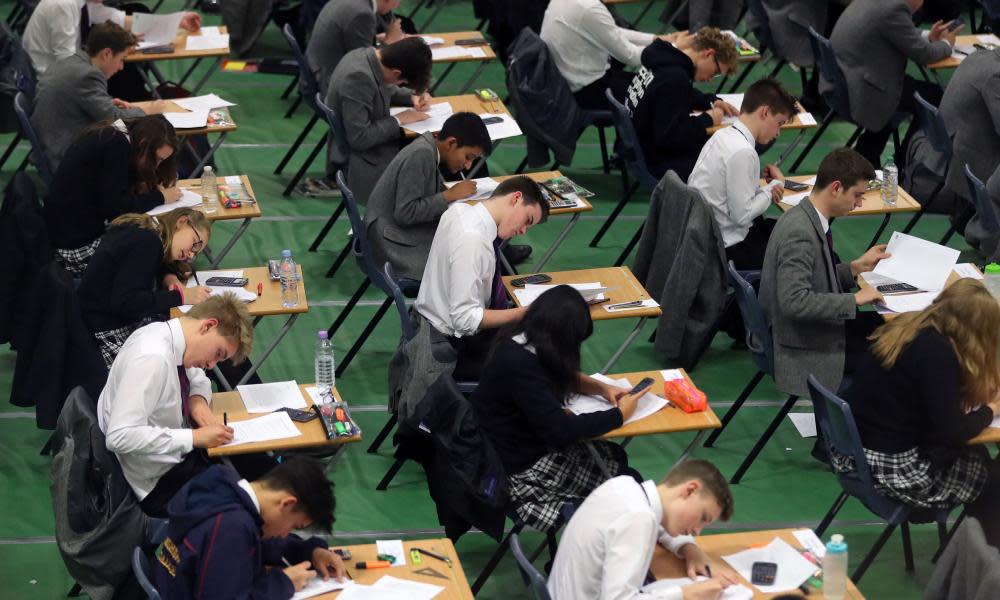 Students sitting a GCSE exam, which will now be graded using a 9-1 system rather than A* to G.