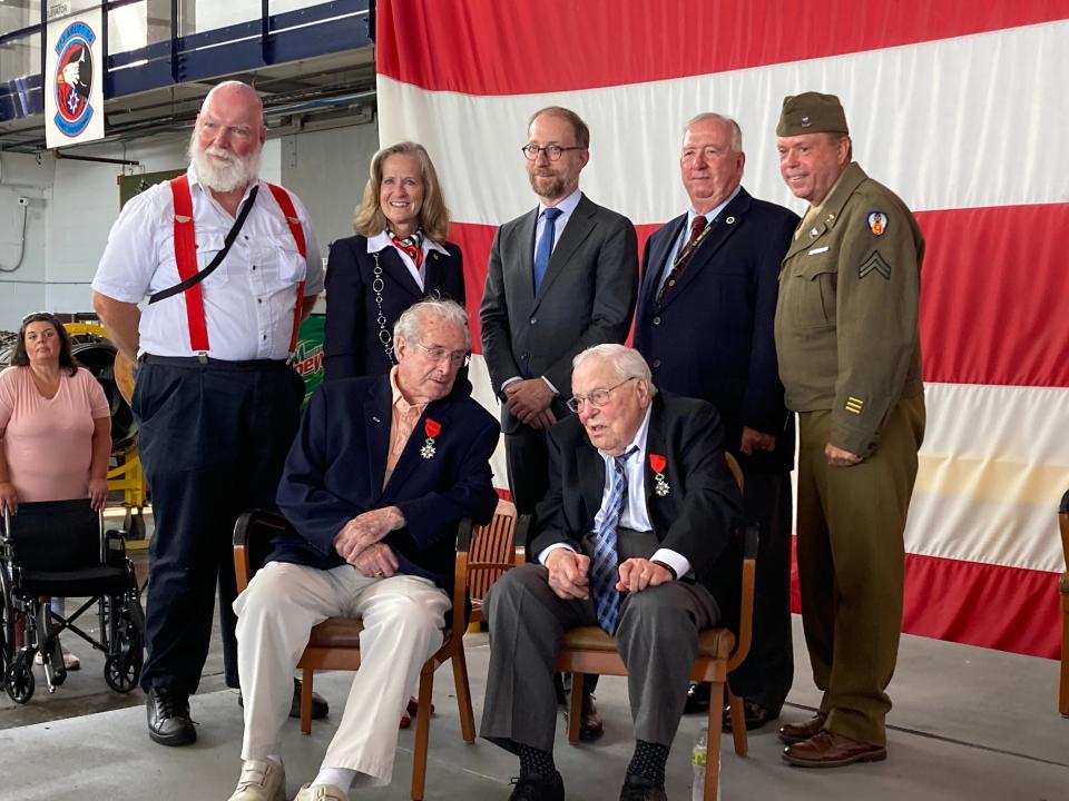 Walter B. Stitt, left, of Springfield, and Leonard Giorgio, of Medina County, talk Saturday morning after receiving the French Legion of Honor. Behind them are, left to right, Richard M Berrong, a French teacher at Kent State University; Maj. Gen. Deborah Ashenhurst, director of the Ohio Department of Veterans Affairs; Yannick Tagand, consul general of France to the Midwest; Col. Reed Kimball, education director of MAPS Air Museum; and Eric P. Montgomery, who helped secure the French Legion of Honor for the veterans.