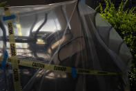 The morning light shines on poolside chairs stacked up with caution tape to prevent people from sitting due to the coronavirus pandemic at a condominium complex in La Habra, Calif., Wednesday, July 8, 2020. (AP Photo/Jae C. Hong)