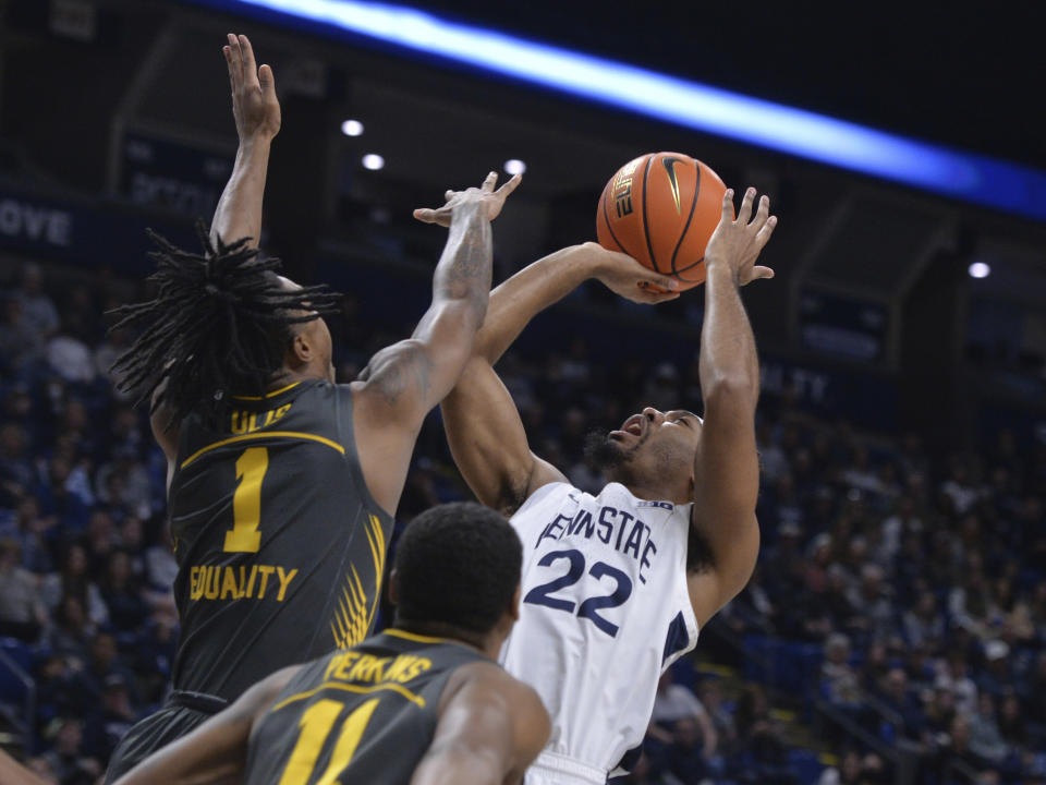 Penn State's Jalen Pickett (22) shoots over Iowa's Ahron Ulis (1) during the first half of an NCAA college basketball game, Sunday, Jan. 1, 2023, in State College, Pa. (AP Photo/Gary M. Baranec)