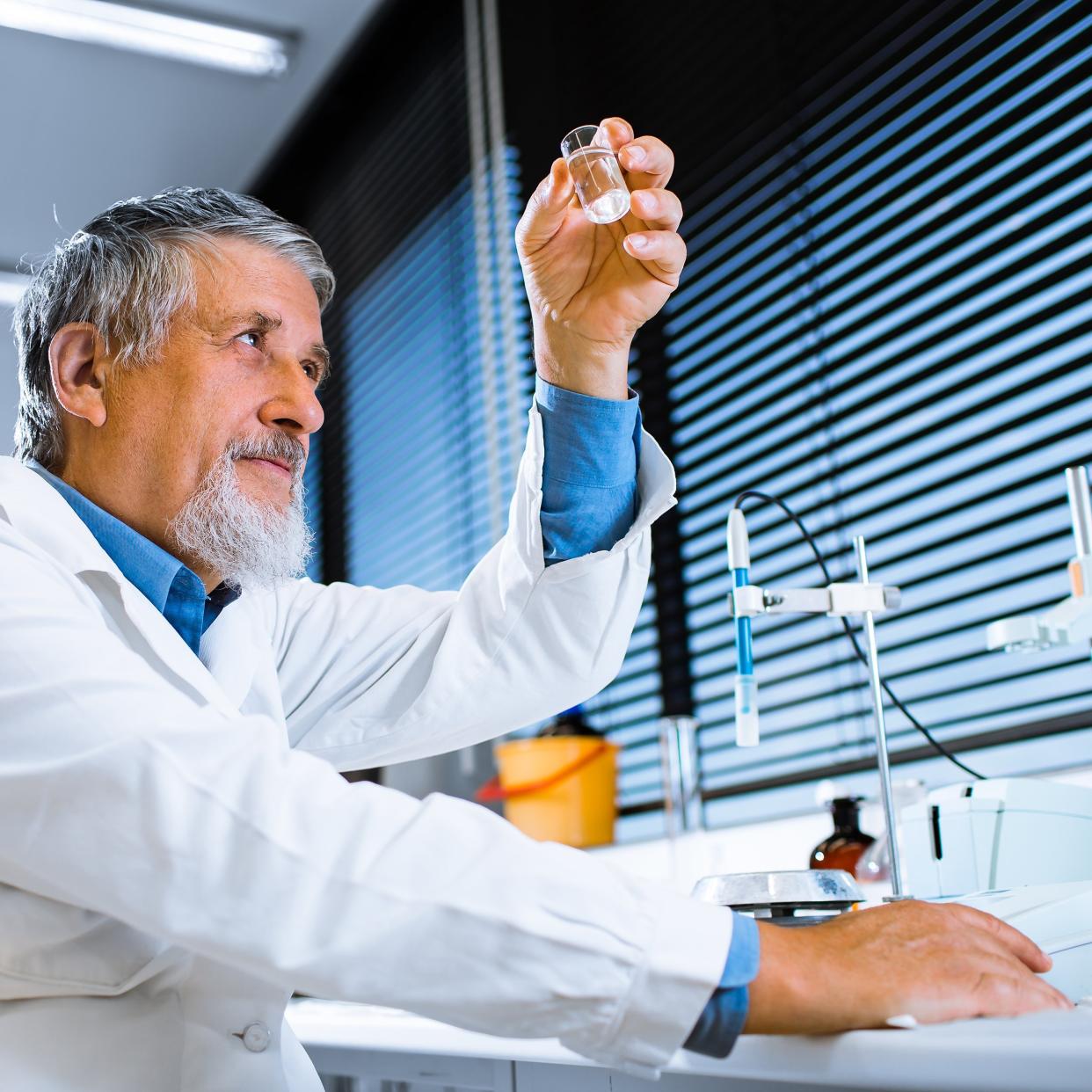 senior male researcher carrying out scientific research in a lab