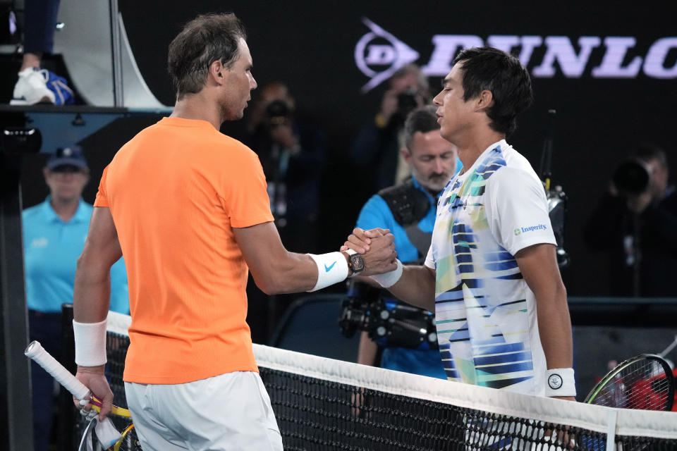 Rafael Nadal, left, of Spain congratulates Mackenzie McDonald of the U.S., following their second round match at the Australian Open tennis championship in Melbourne, Australia, Wednesday, Jan. 18, 2023. (AP Photo/Dita Alangkara)
